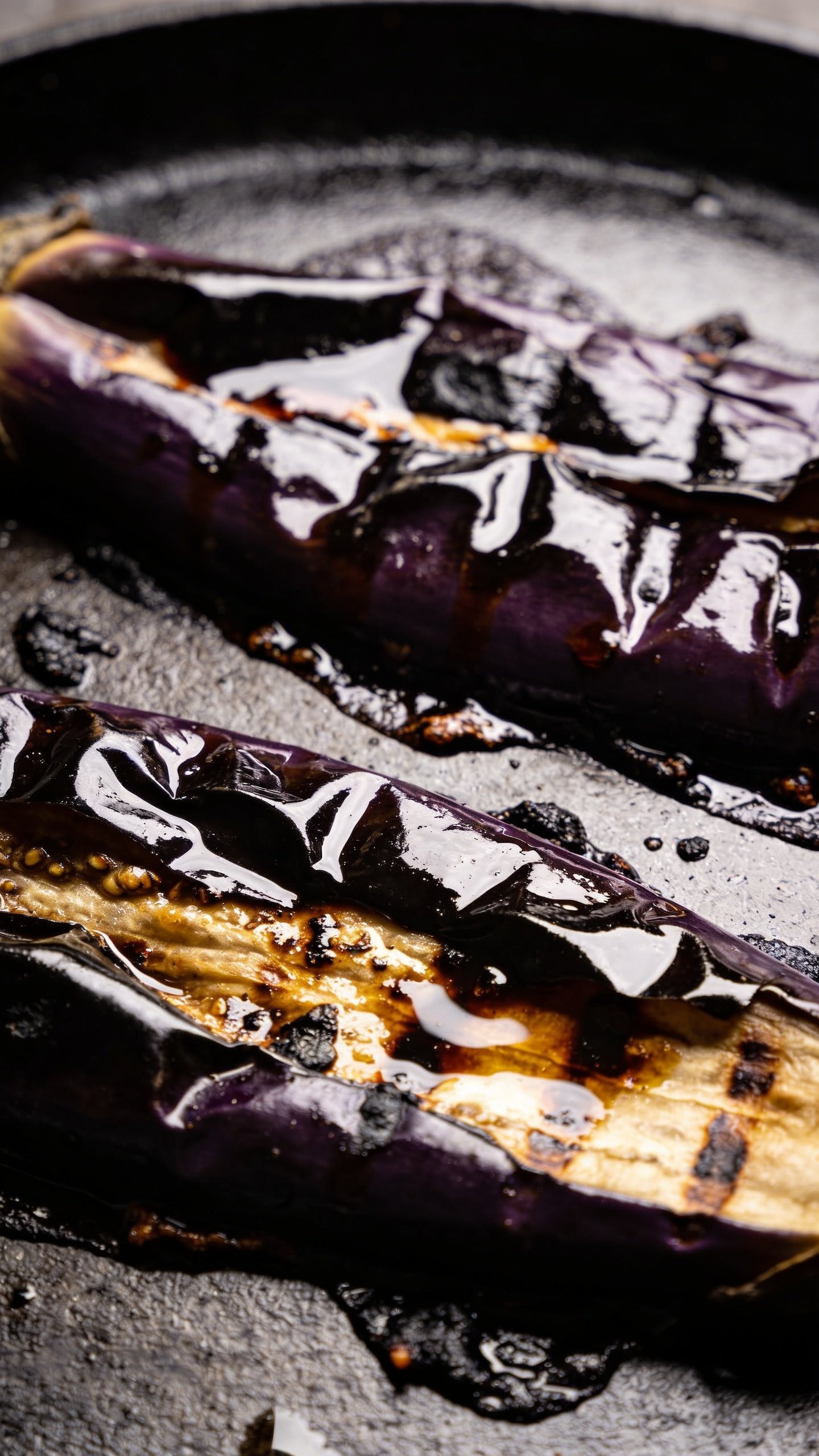 closeup of charred eggplant glaze on skillet surface