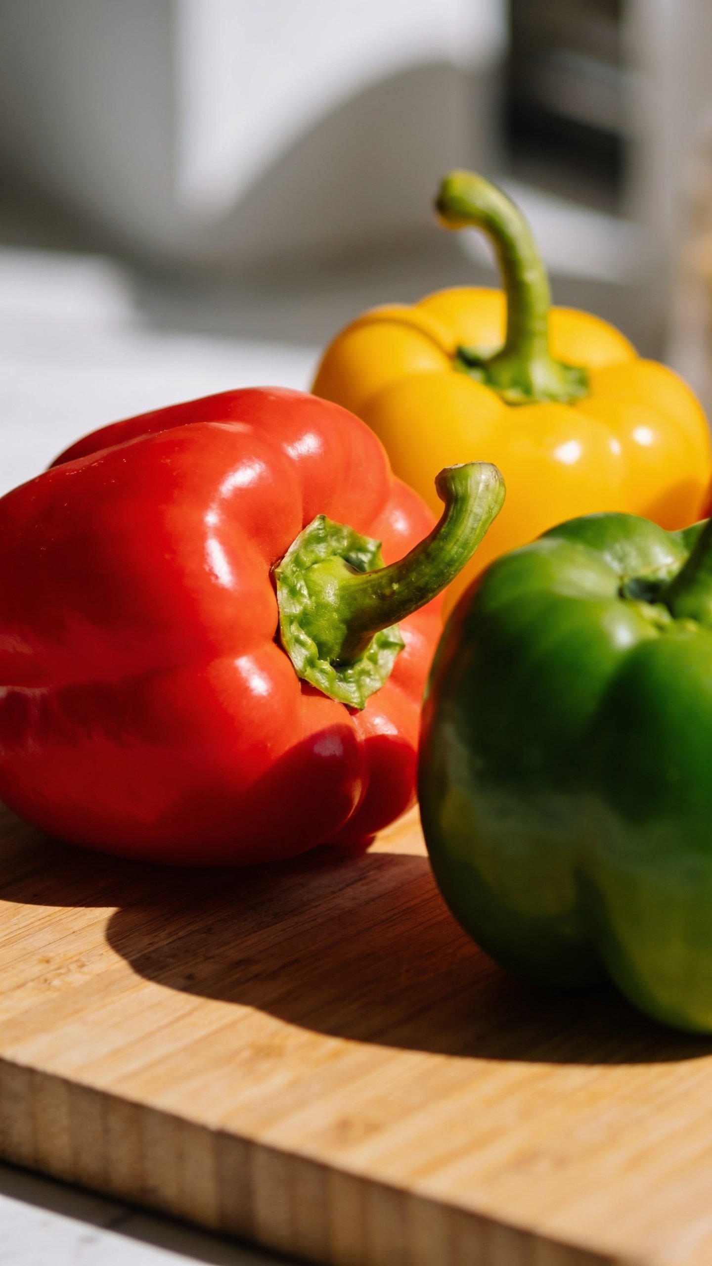 Closeup of crisp colorful bell peppers on a cutting board